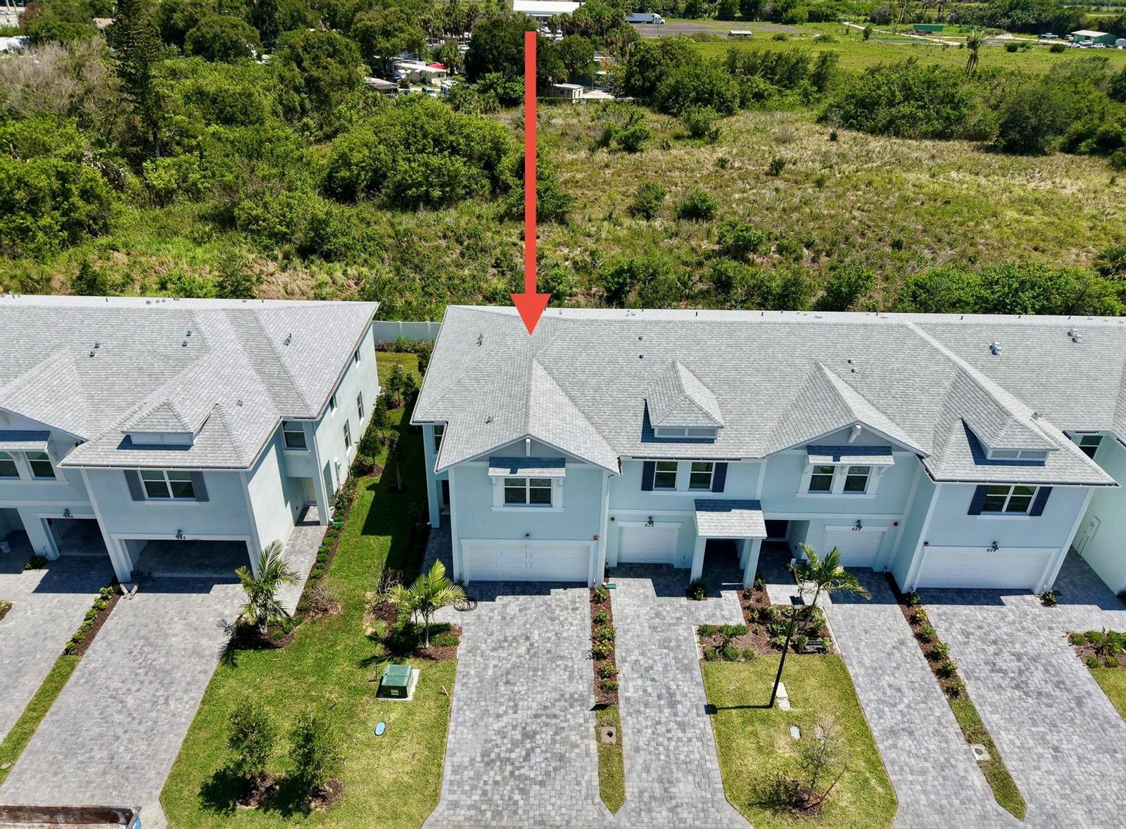 An aerial view shows a row of light blue townhouses with gray shingled roofs — 636 Salisbury Circle, Fort Pierce FL 34982, FORT PIERCE, FL