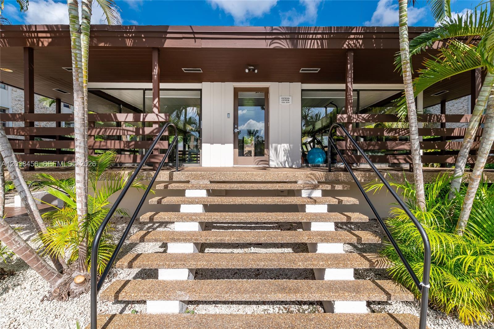 A set of concrete stairs leads to the entrance of a building with a fitness center — 7483 SW 82nd St # A206, Miami FL 33143, MIAMI, FL