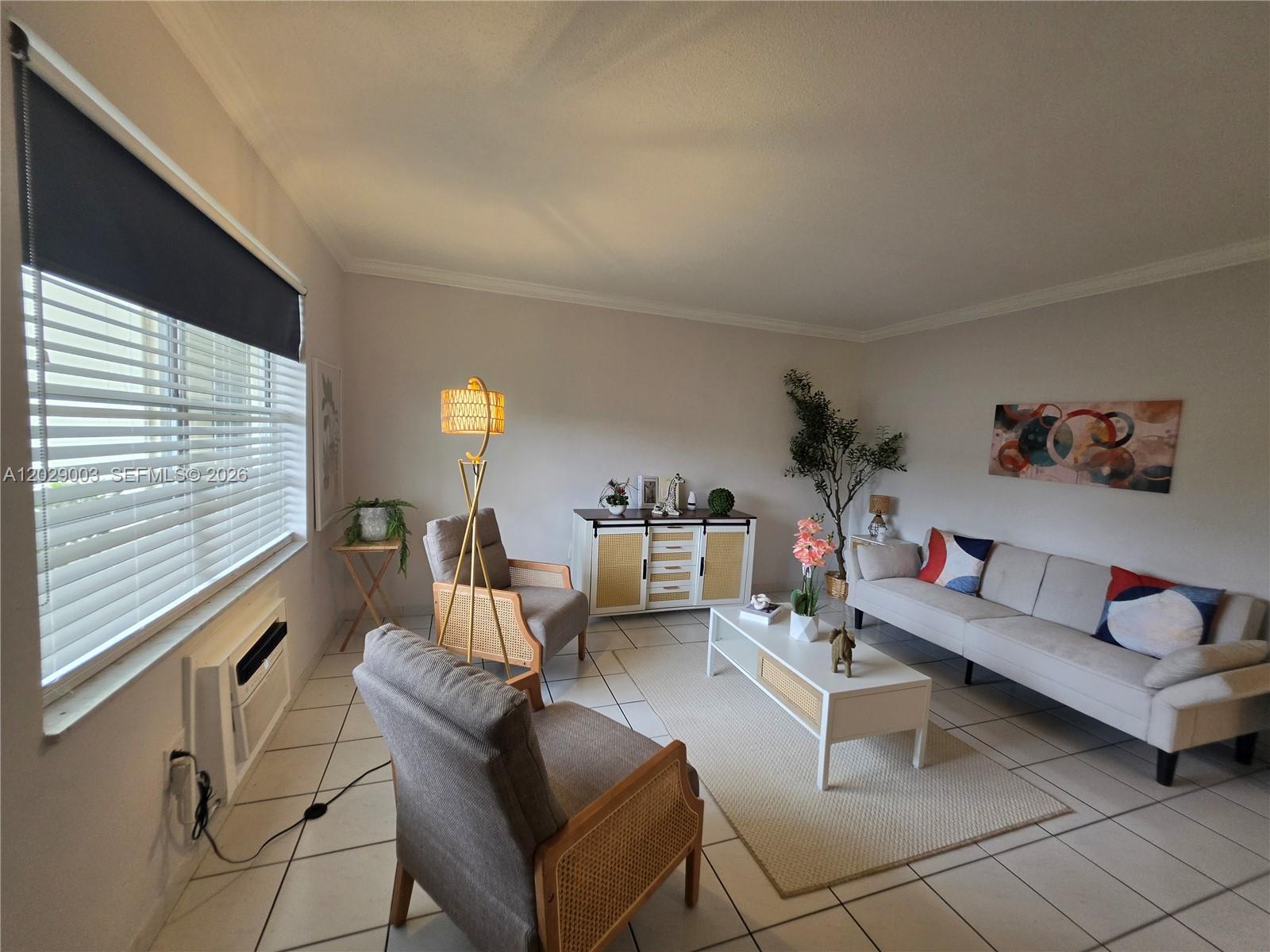 A living room features light-colored tile floors, a sofa, two armchairs, and a coffee table — 17000 NE 14th Ave # 109, Miami FL 33162, MIAMI, FL