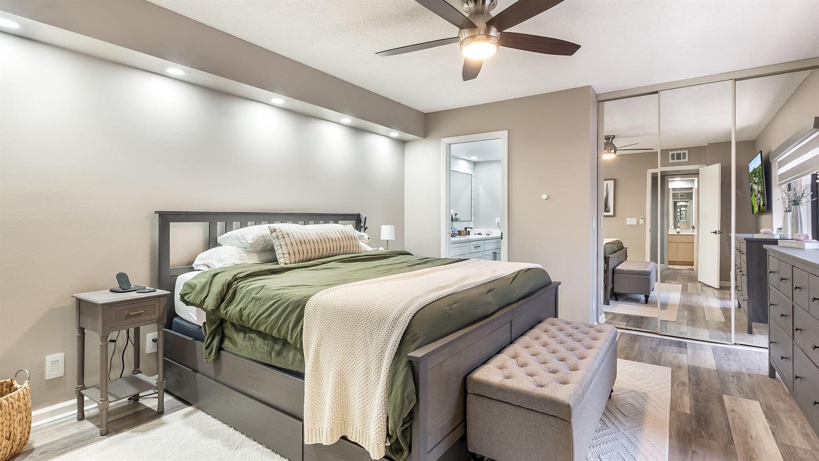 A bedroom features a gray bed, a tufted bench, and mirrored closet doors — 725 NW 99th Circle, Plantation FL 33324, PLANTATION, FL