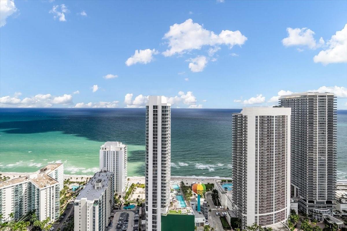 An aerial view of high-rise apartment buildings along a sandy beach and the ocean — 4010 S Ocean Drive # R1102, Hollywood FL 33019, HOLLYWOOD, FL
