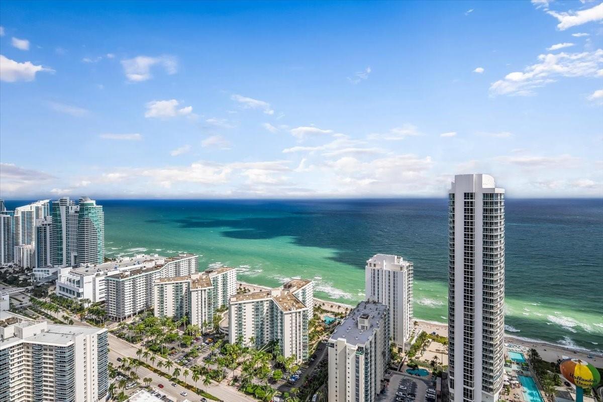 An aerial view of high-rise buildings along a sandy beach and the turquoise ocean — 4010 S Ocean Drive # R1102, Hollywood FL 33019, HOLLYWOOD, FL
