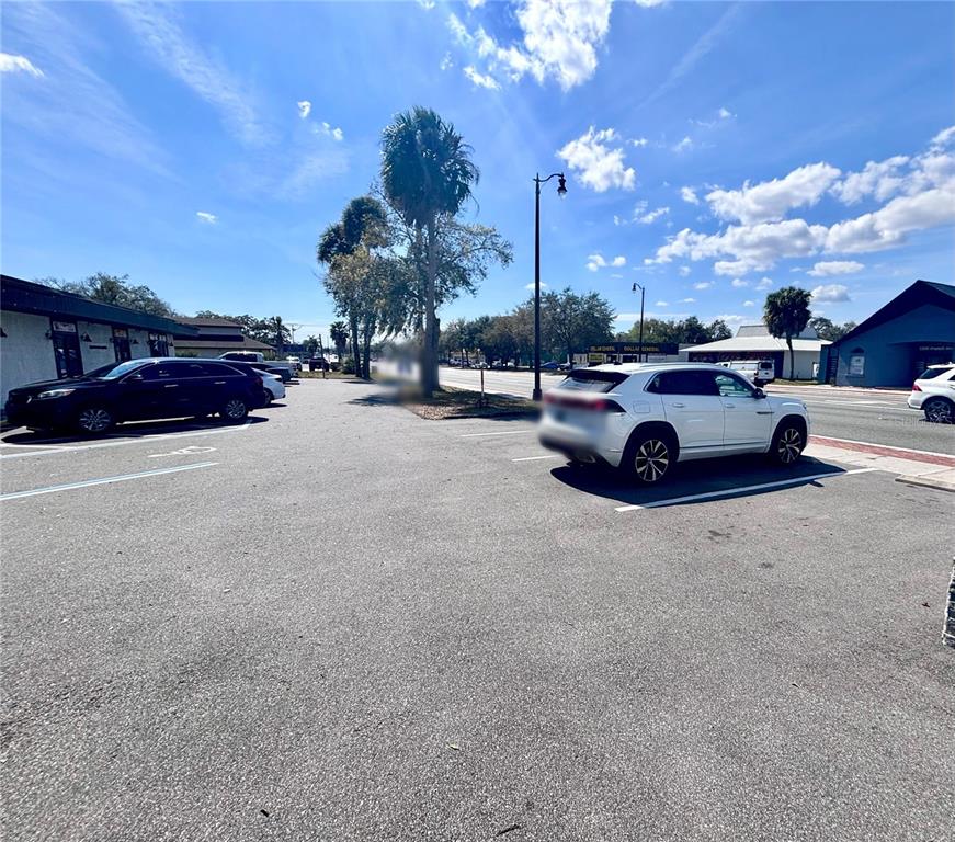 A paved parking lot with a white SUV and a black SUV parked in spaces — 2201 S FRENCH AVENUE, SANFORD, FL