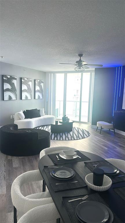 A modern living and dining area features a curved white sofa, black furniture, and floor-to-ceiling windows — 231 RIVERSIDE DRIVE UNIT 708-1, HOLLY HILL, FL