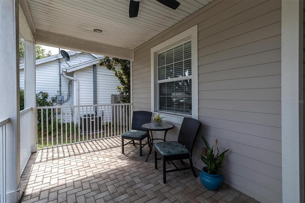 A foyer with light blue walls, hardwood floors, a wooden console table, and a front door — 6020 MONTANA AVENUE, NEW PORT RICHEY, FL