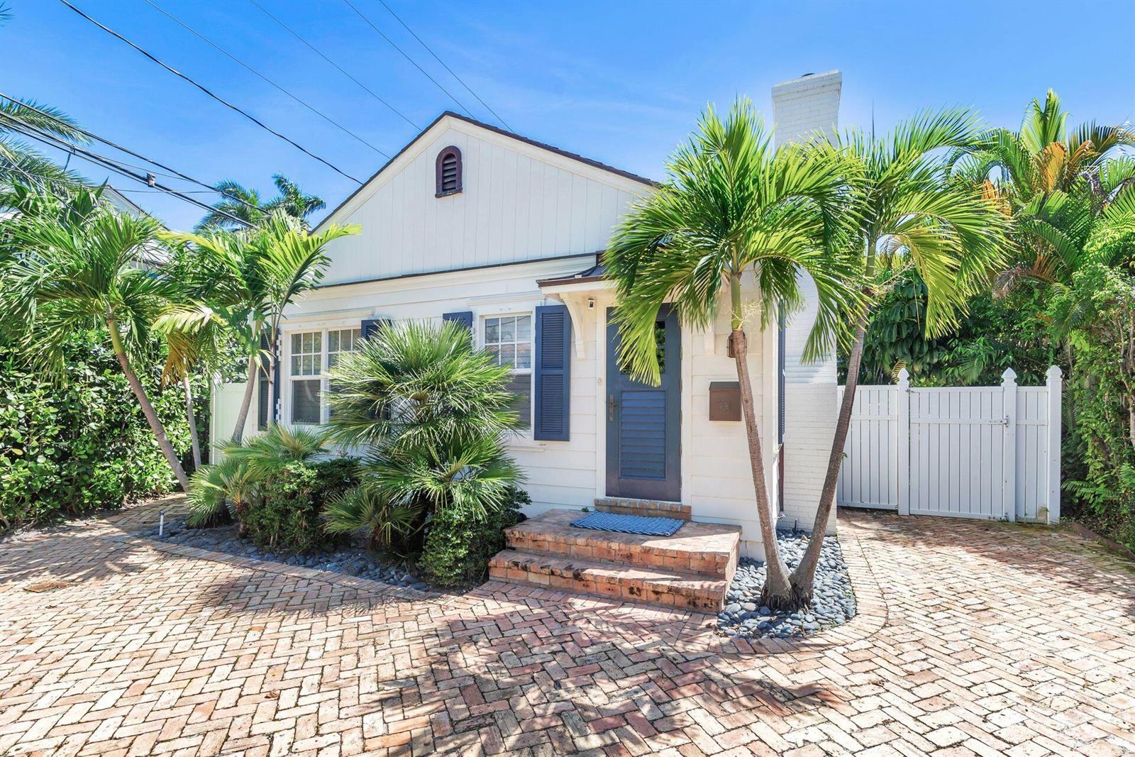 A white cottage with a brick driveway, palm trees, and a dark blue front door — 231 Cocoanut Row, Palm Beach FL 33480, PALM BEACH, FL