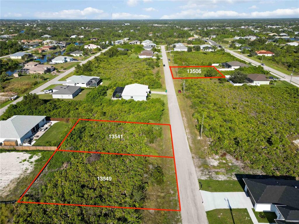 An aerial view shows three vacant residential lots outlined in red along a paved road — 13549 ABUTILON LANE, PORT CHARLOTTE, FL