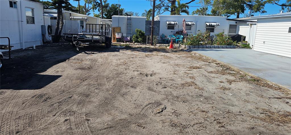 A dirt lot with tire tracks sits between two mobile homes and a trailer — 69 W 4TH STREET W UNIT 69-4, BRADENTON, FL