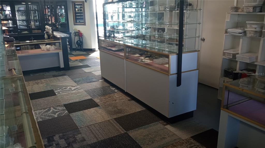 An interior view of a retail jewelry store featuring glass display cases and carpeted flooring — 1460 S MCCALL ROAD UNIT 3F, ENGLEWOOD, FL