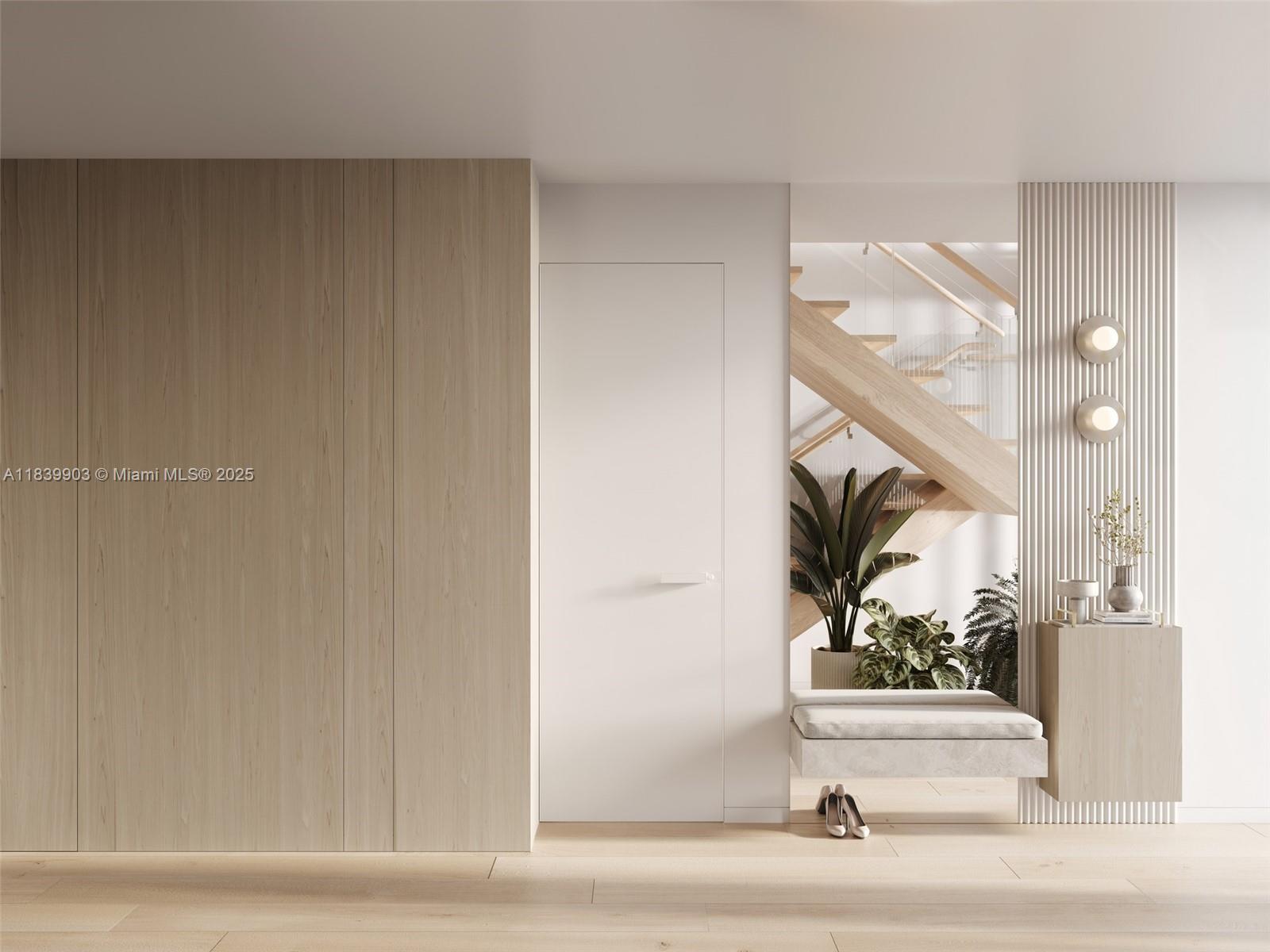 This rendering shows a modern entryway with wood paneling, a white door, and a staircase — 1709 Jefferson Ave # 08, Miami Beach FL 33139, MIAMI BEACH, FL