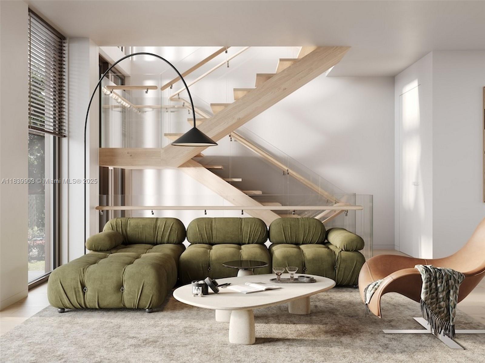 This rendering shows a living room with a green tufted sofa, coffee table, and staircase — 1709 Jefferson Ave # 08, Miami Beach FL 33139, MIAMI BEACH, FL