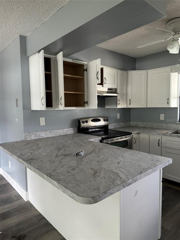 A kitchen features white cabinets, gray walls, and a gray marble-patterned laminate countertop — 38745 CAMBRIDGE DRIVE, ZEPHYRHILLS, FL