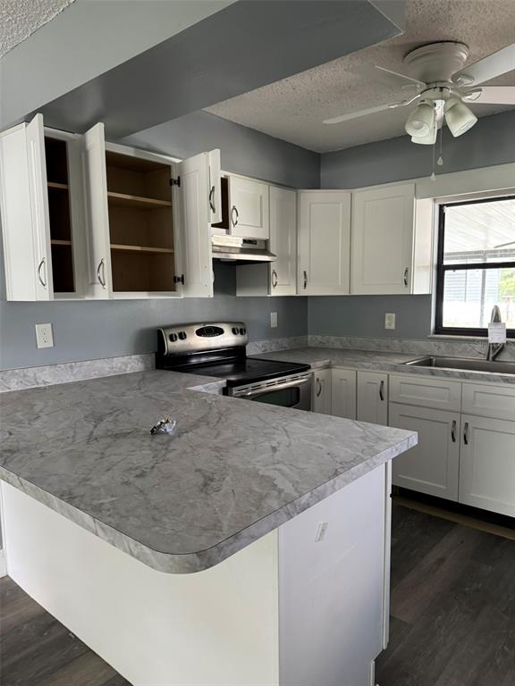 A kitchen features white cabinets, grey marble-patterned countertops, stainless steel appliances, and grey walls — 38745 CAMBRIDGE DRIVE, ZEPHYRHILLS, FL
