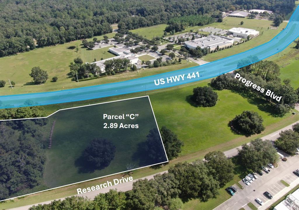 An aerial view shows a vacant 2.89-acre parcel of land near a highway and road — RESEARCH DRIVE, ALACHUA, FL