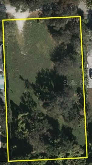 An aerial view shows a rectangular, tree-covered vacant lot outlined in yellow — tbd SW 93RD STREET, MIAMI, FL