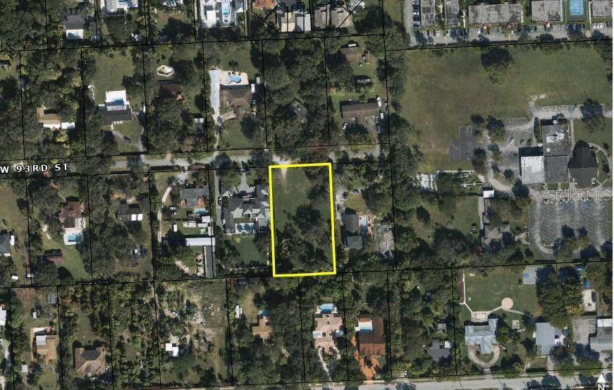 An aerial view shows a vacant rectangular lot outlined in yellow within a residential neighborhood — tbd SW 93RD STREET, MIAMI, FL