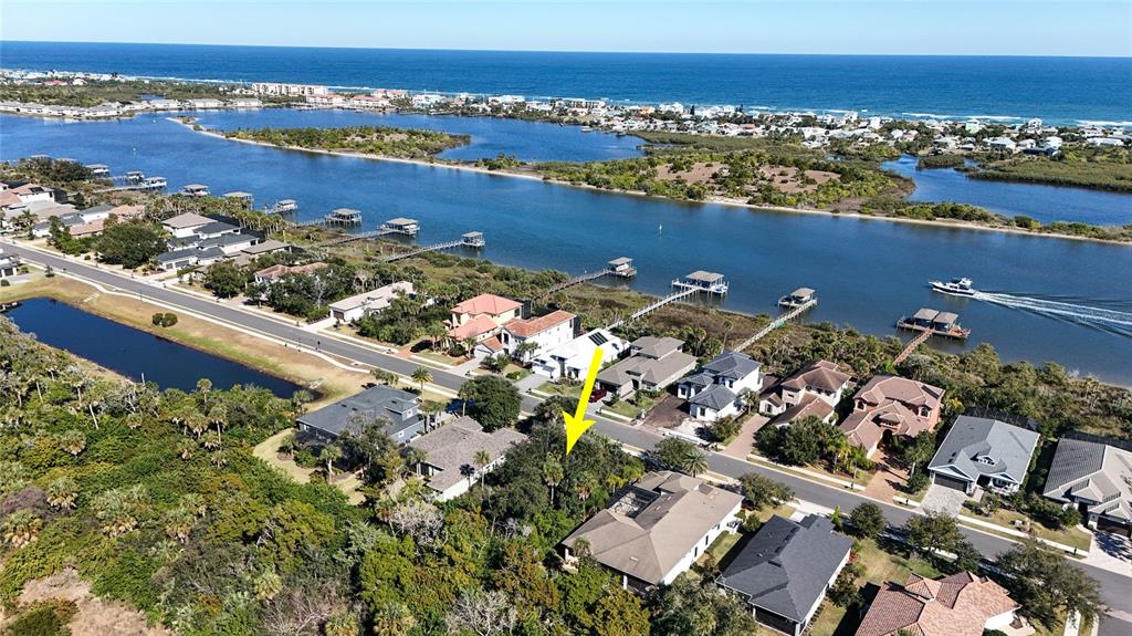 An aerial view shows a residential neighborhood with a yellow arrow pointing toward a house — 284 S RIVERWALK DRIVE, PALM COAST, FL