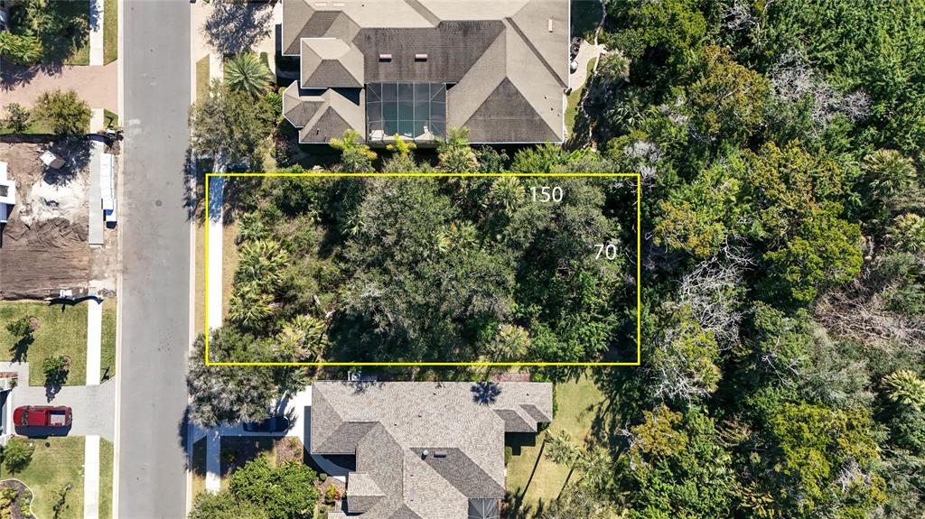 This aerial view shows a rectangular vacant lot outlined in yellow between two residential houses — 284 S RIVERWALK DRIVE, PALM COAST, FL