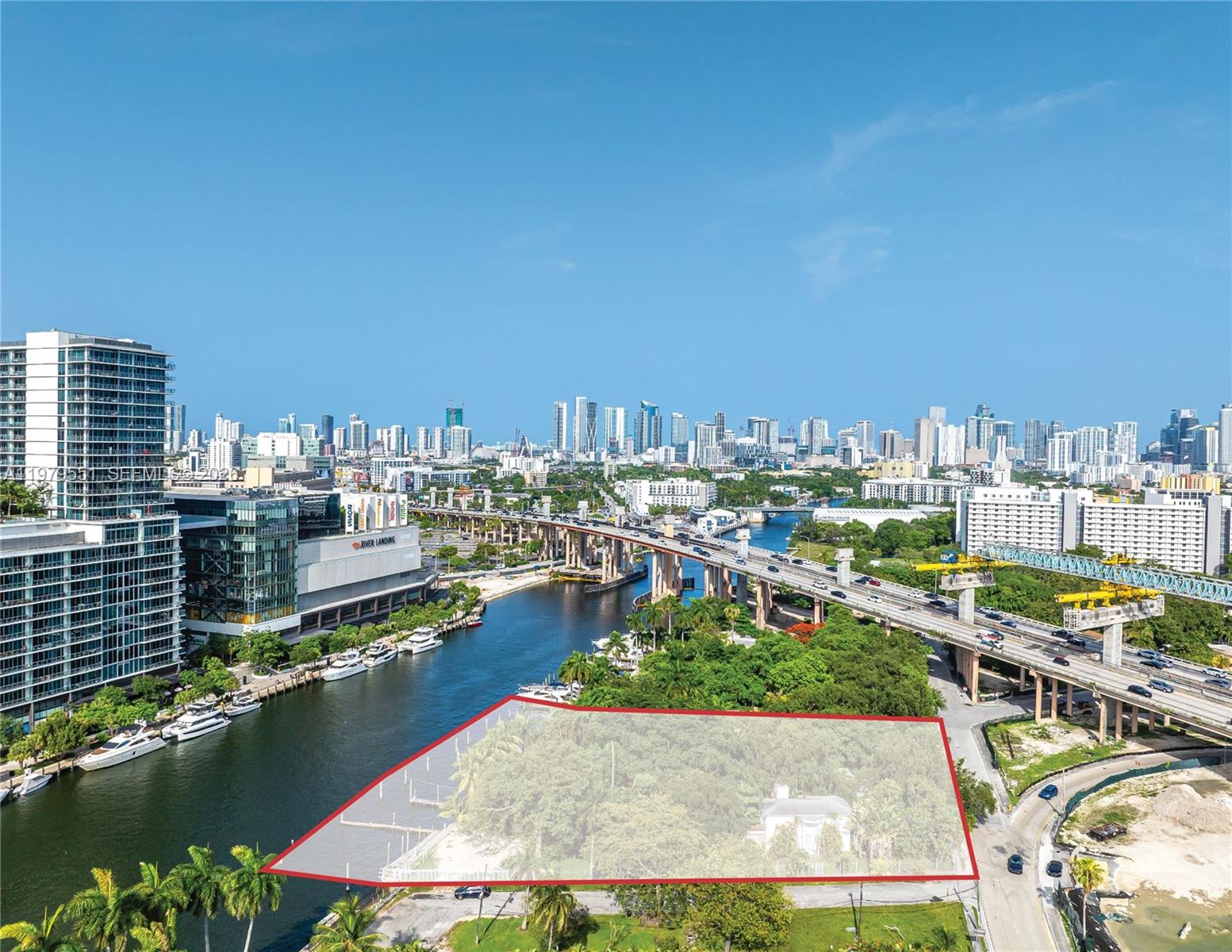 An aerial view shows a waterfront lot highlighted in red next to a highway bridge — 1515 NW North River Dr, Miami FL 33125, MIAMI, FL