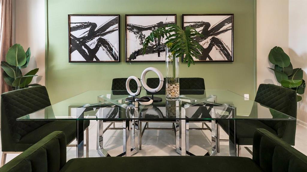 A dining room features a glass-topped table, dark green upholstered chairs, and three abstract paintings — 5844 ENERGY WAY, CLERMONT, FL
