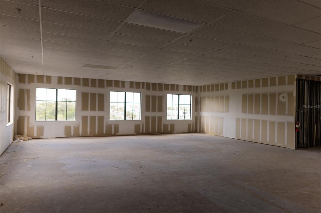 An unfinished commercial office space with drywall, exposed concrete floors, and a drop ceiling — 5920 PAN AMERICAN BOULEVARD UNIT 310, NORTH PORT, FL