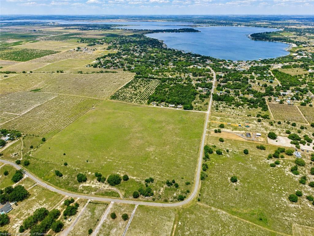An aerial view shows a large, open grassy field bordered by roads and nearby residential areas — LAKE PATRICK ROAD N, BABSON PARK, FL