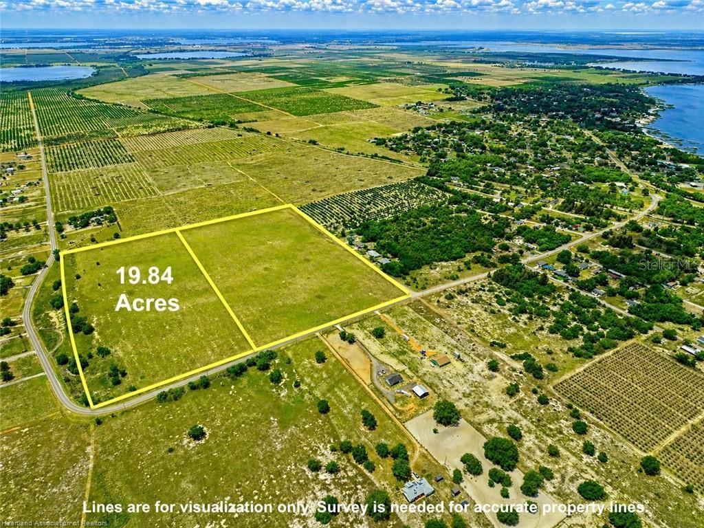 An aerial view shows a large, rectangular plot of undeveloped land outlined in yellow — LAKE PATRICK ROAD N, BABSON PARK, FL