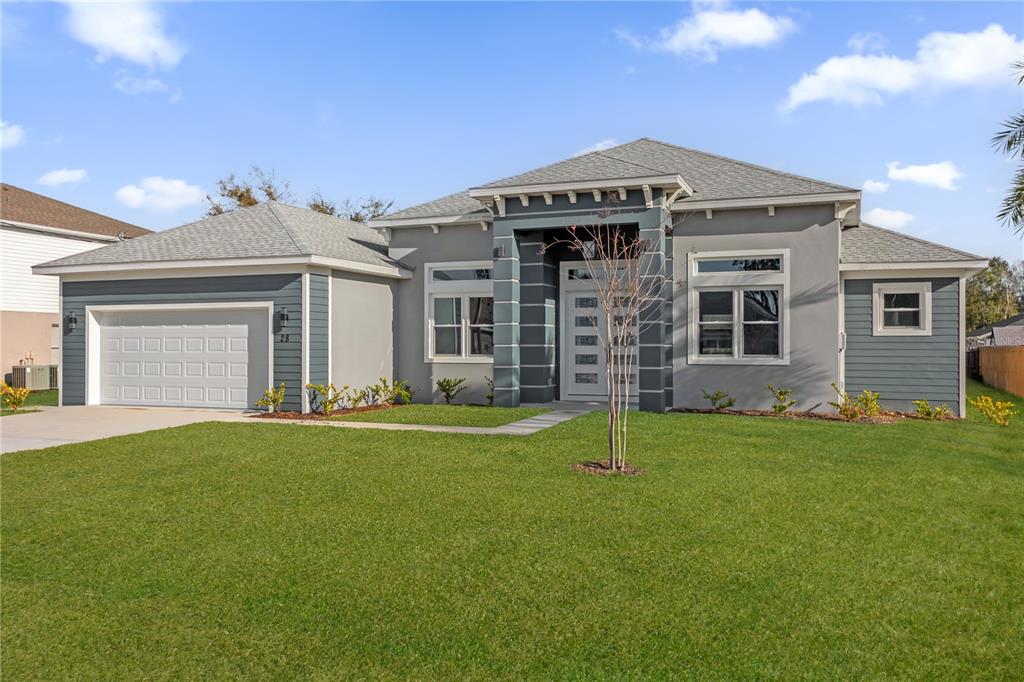 A single-story house with a gray exterior, a two-car garage, and a front entryway — 28 BUFFALO BILL DRIVE, PALM COAST, FL