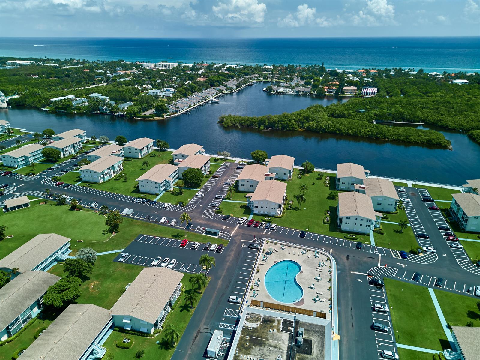 An aerial view shows a residential complex with multiple buildings, a swimming pool, and parking lots — 880 Horizons W # 102, Boynton Beach FL 33435, BOYNTON BEACH, FL