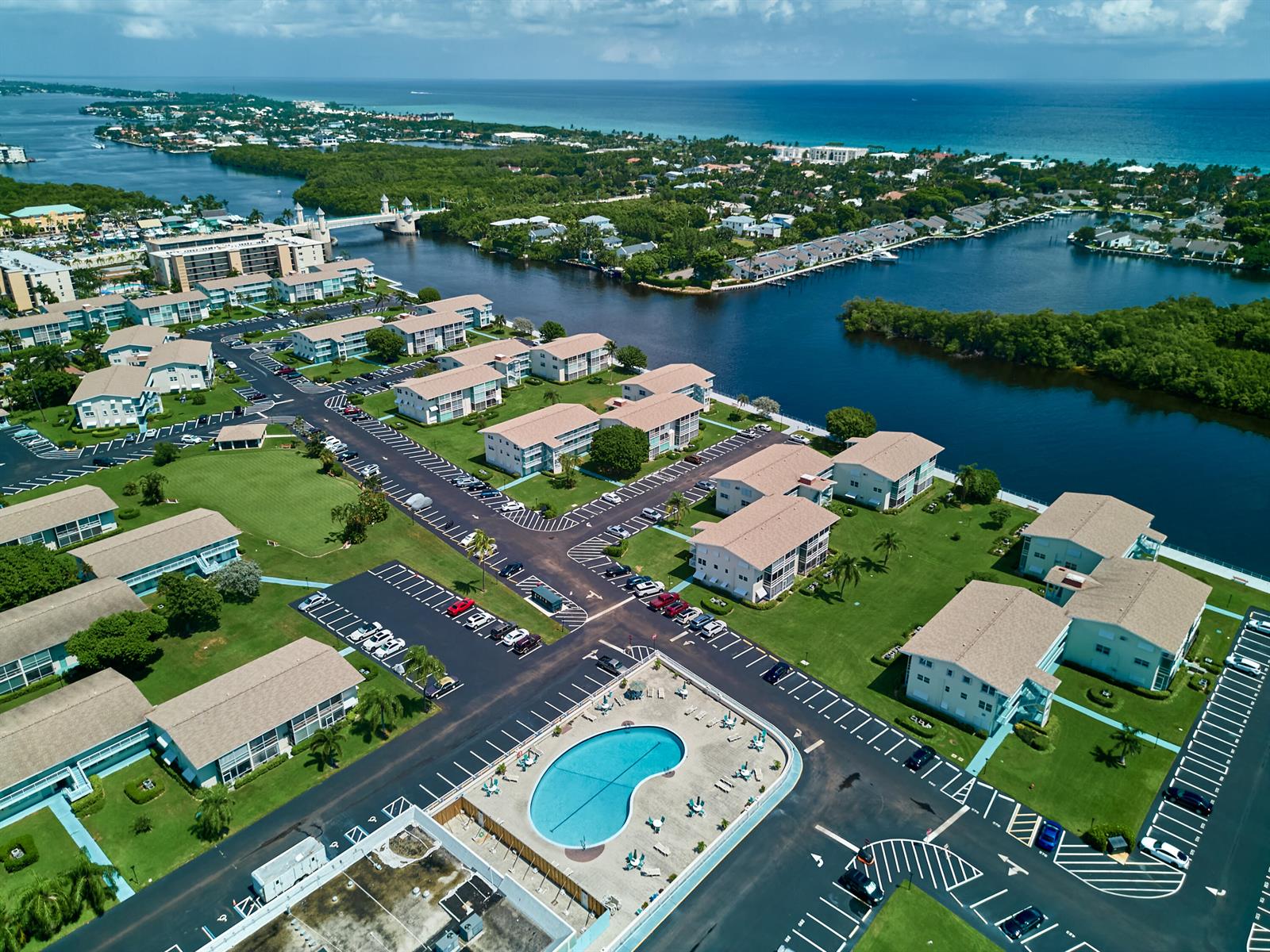 Aerial view of a waterfront residential complex with multiple apartment buildings, parking lots, and pools — 880 Horizons W # 102, Boynton Beach FL 33435, BOYNTON BEACH, FL