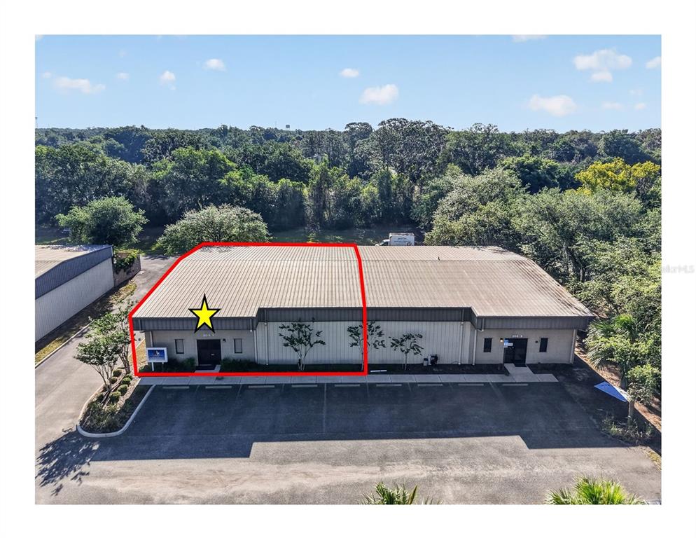 An aerial view shows a commercial warehouse building with a red outline highlighting one unit — 304 RICHEY ROAD UNIT 1, LEESBURG, FL