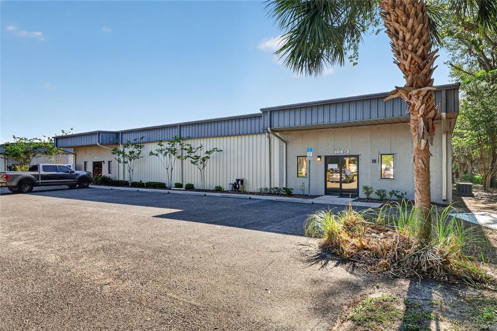A single-story commercial building with a metal roof and a paved parking lot — 304 RICHEY ROAD UNIT 1, LEESBURG, FL