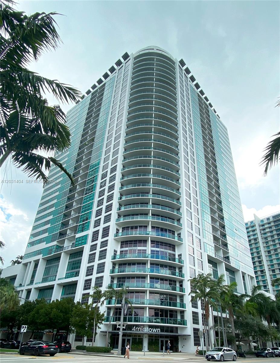 A low-angle view of the 4midtown high-rise residential building with balconies and palm trees — 3301 NE 1st Ave # H1206, Miami FL 33137, MIAMI, FL