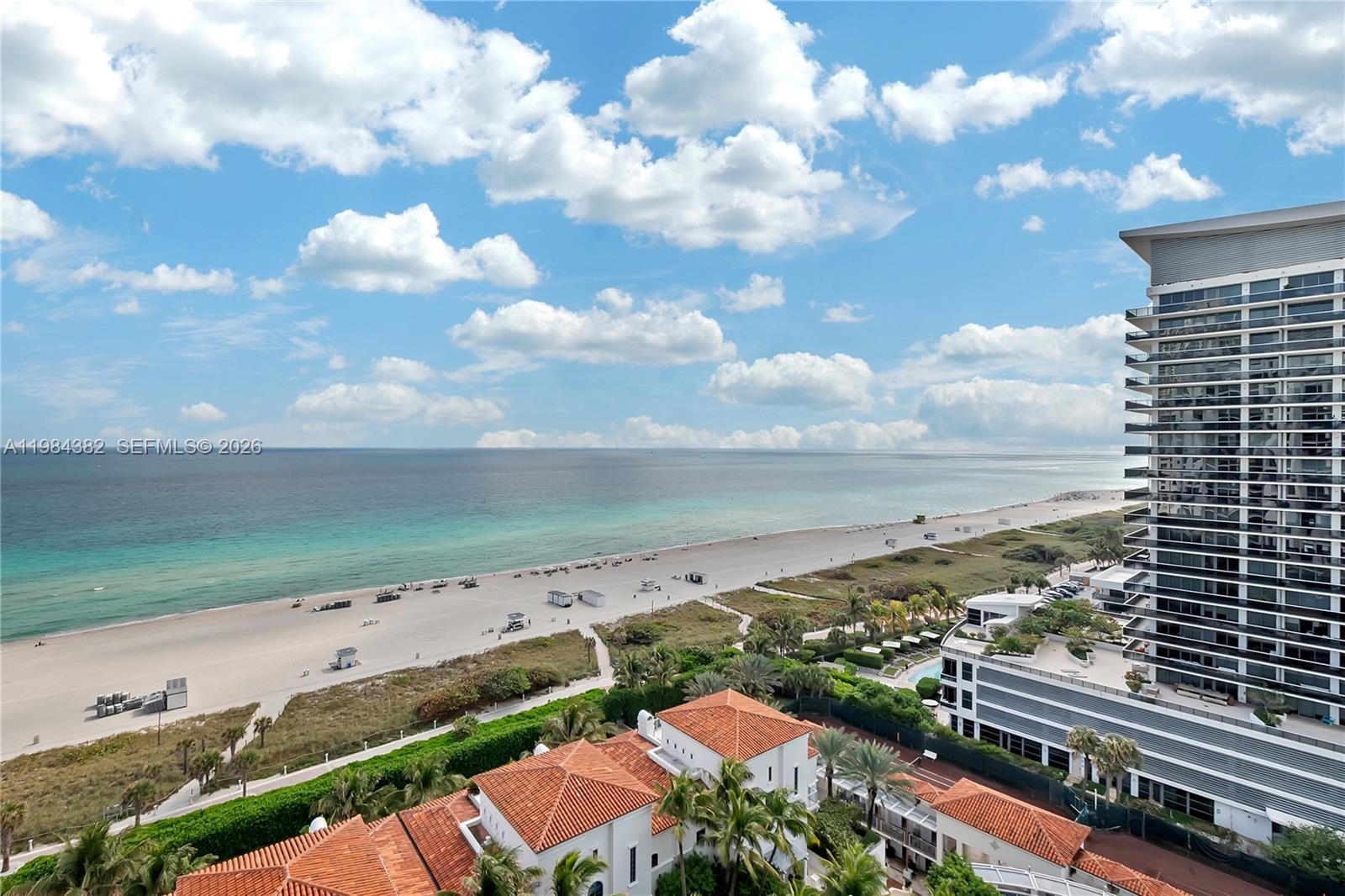An elevated view shows a sandy beach, the ocean, and nearby residential buildings — 5959 Collins Ave # 1503, Miami Beach FL 33140, MIAMI BEACH, FL