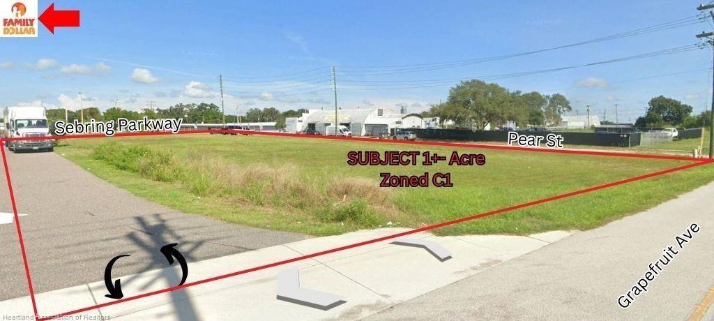 This is a real estate listing photo showing a vacant, grassy lot outlined in red — 648 N Ridgewood Drive, Sebring FL 33870, SEBRING, FL