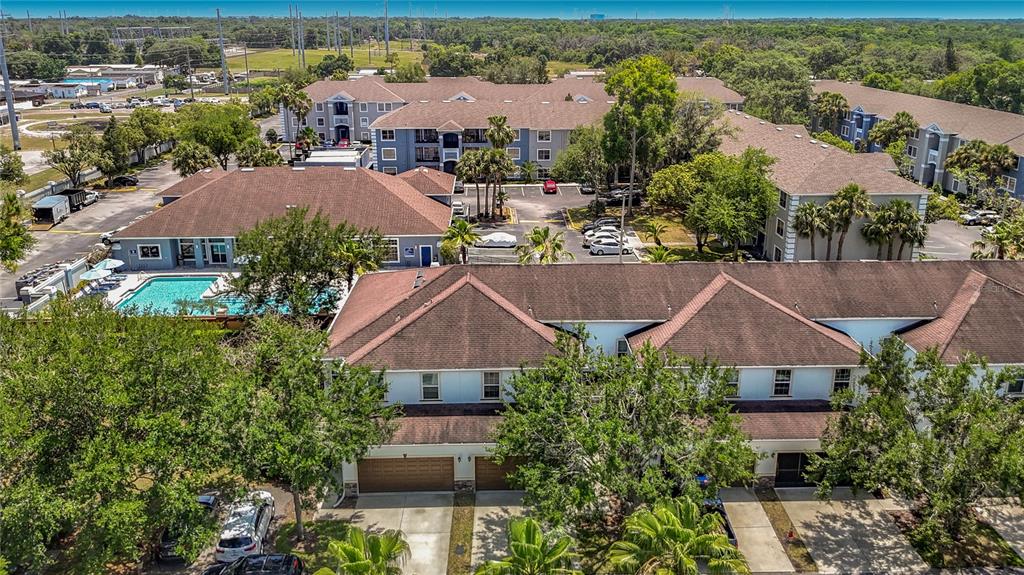 An aerial view of a multi-story apartment complex with a swimming pool and parking lot — 8615 ANDALUCIA FIELD DRIVE, TAMPA, FL