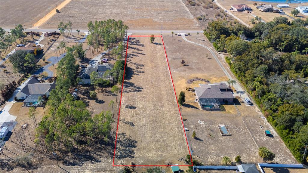 An aerial view shows a rectangular vacant lot outlined in red between two residential properties — 0 S SCENIC HWY, LAKE WALES, FL