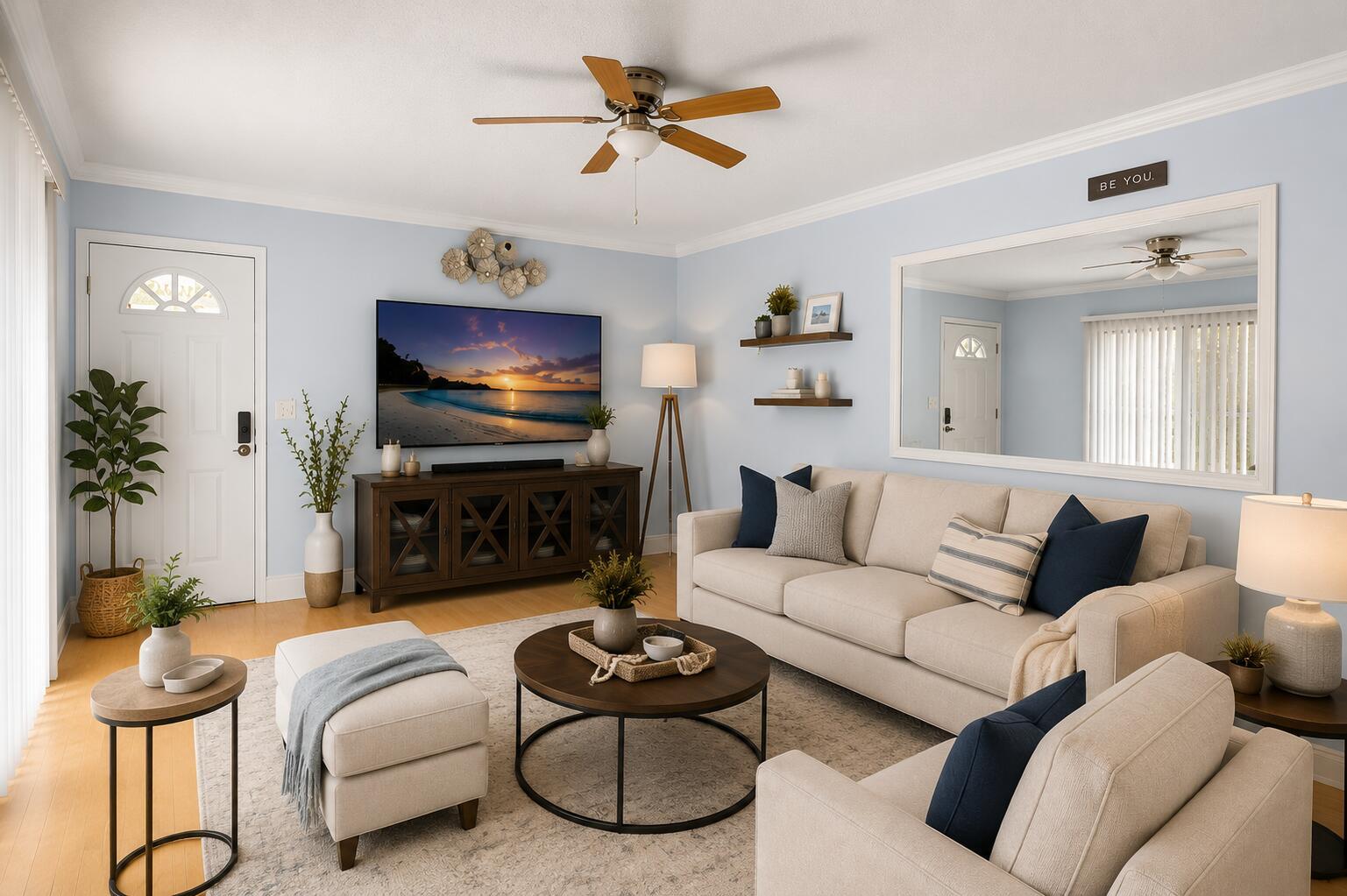 A bright living room features light blue walls, a beige sofa, and a ceiling fan — 6139 Seven Springs Boulevard, FL 33463, FL