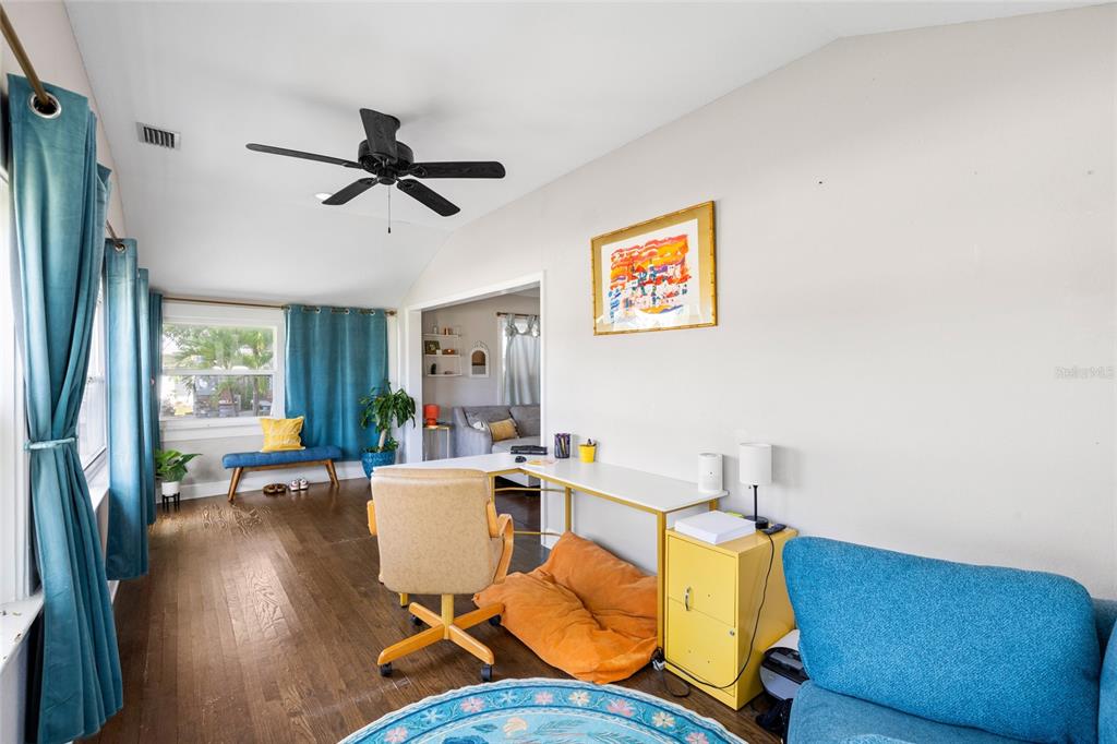 A home office features a white desk, a tan chair, and hardwood floors — 466 36TH AVENUE N, ST PETERSBURG, FL