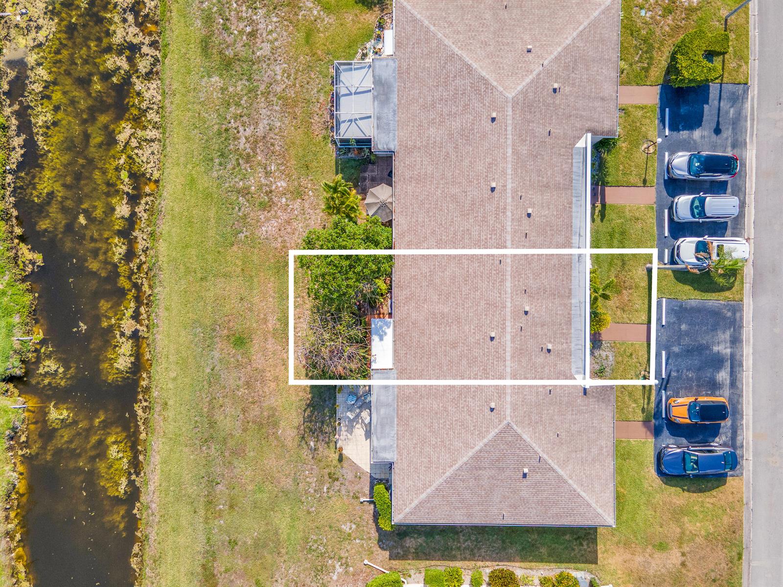 An aerial view shows a residential building with a highlighted unit, parking spaces, and a canal — 8932 Warwick Drive # 419, Boca Raton FL 33433, BOCA RATON, FL