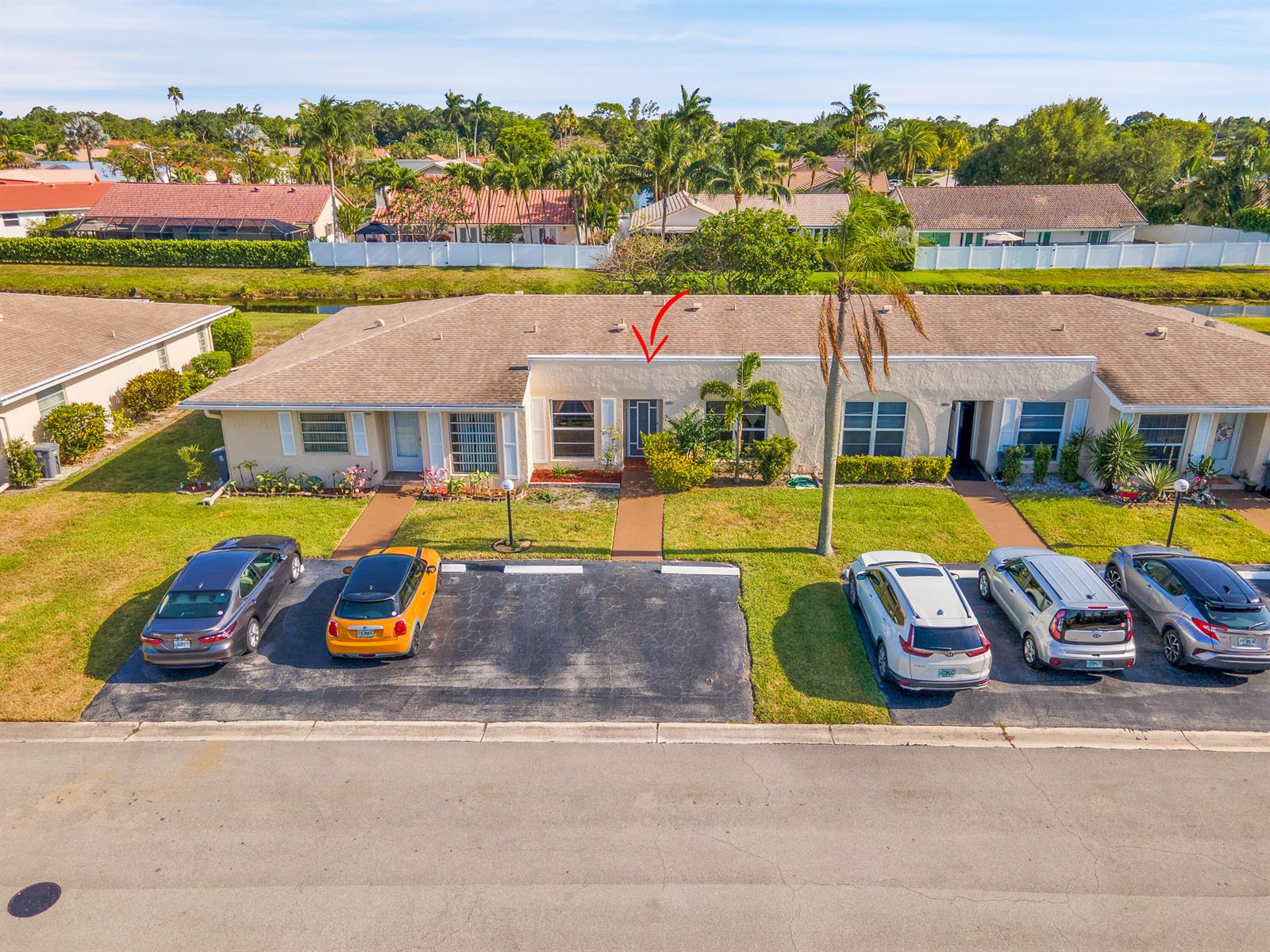 An aerial view shows a single-story multi-unit residential building with a parking lot in front — 8932 Warwick Drive # 419, Boca Raton FL 33433, BOCA RATON, FL