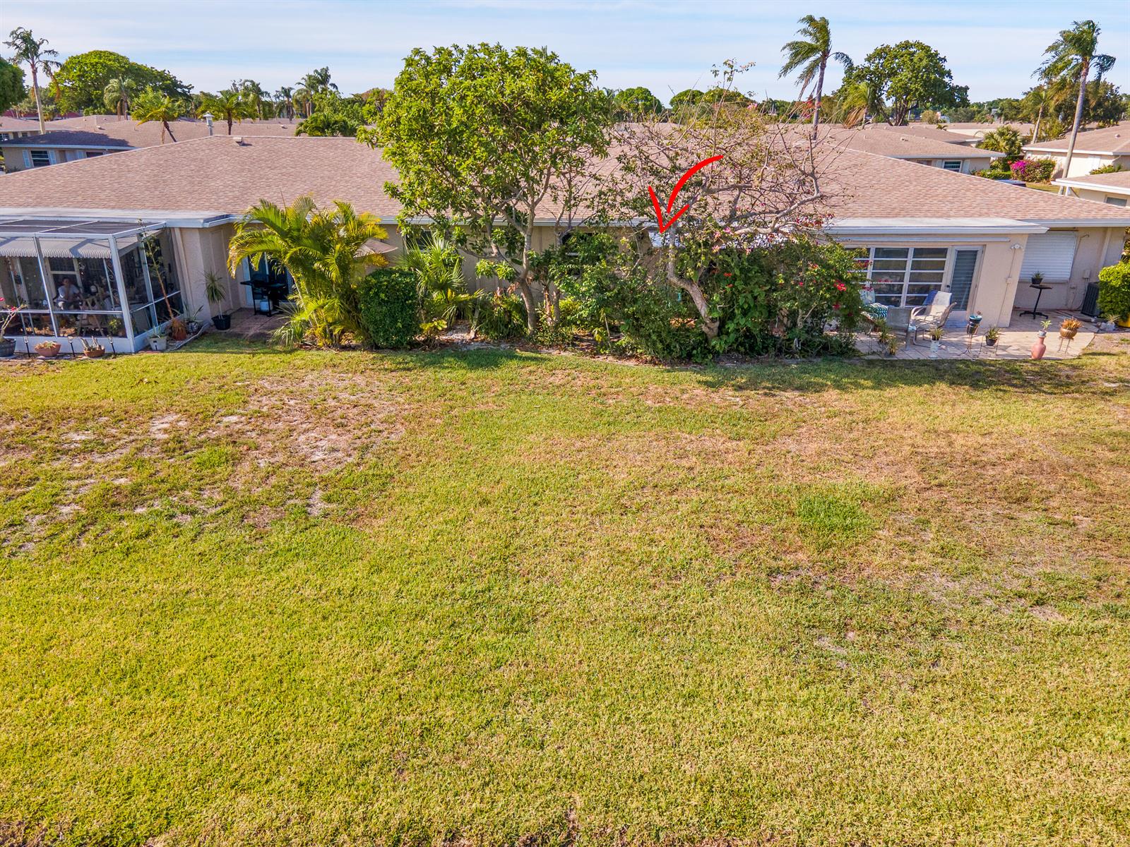 An exterior view of a residential house with a large lawn and mature landscaping — 8932 Warwick Drive # 419, Boca Raton FL 33433, BOCA RATON, FL