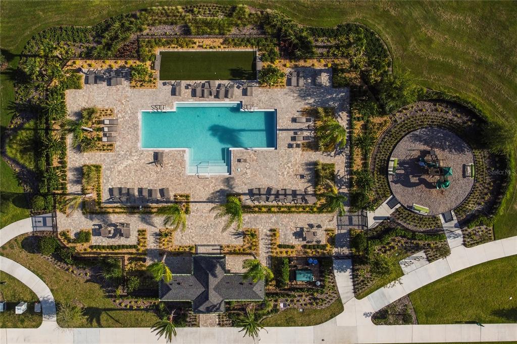 An aerial view shows a community swimming pool, a playground, and a clubhouse with landscaping — 2196 RED SUN STREET, APOPKA, FL