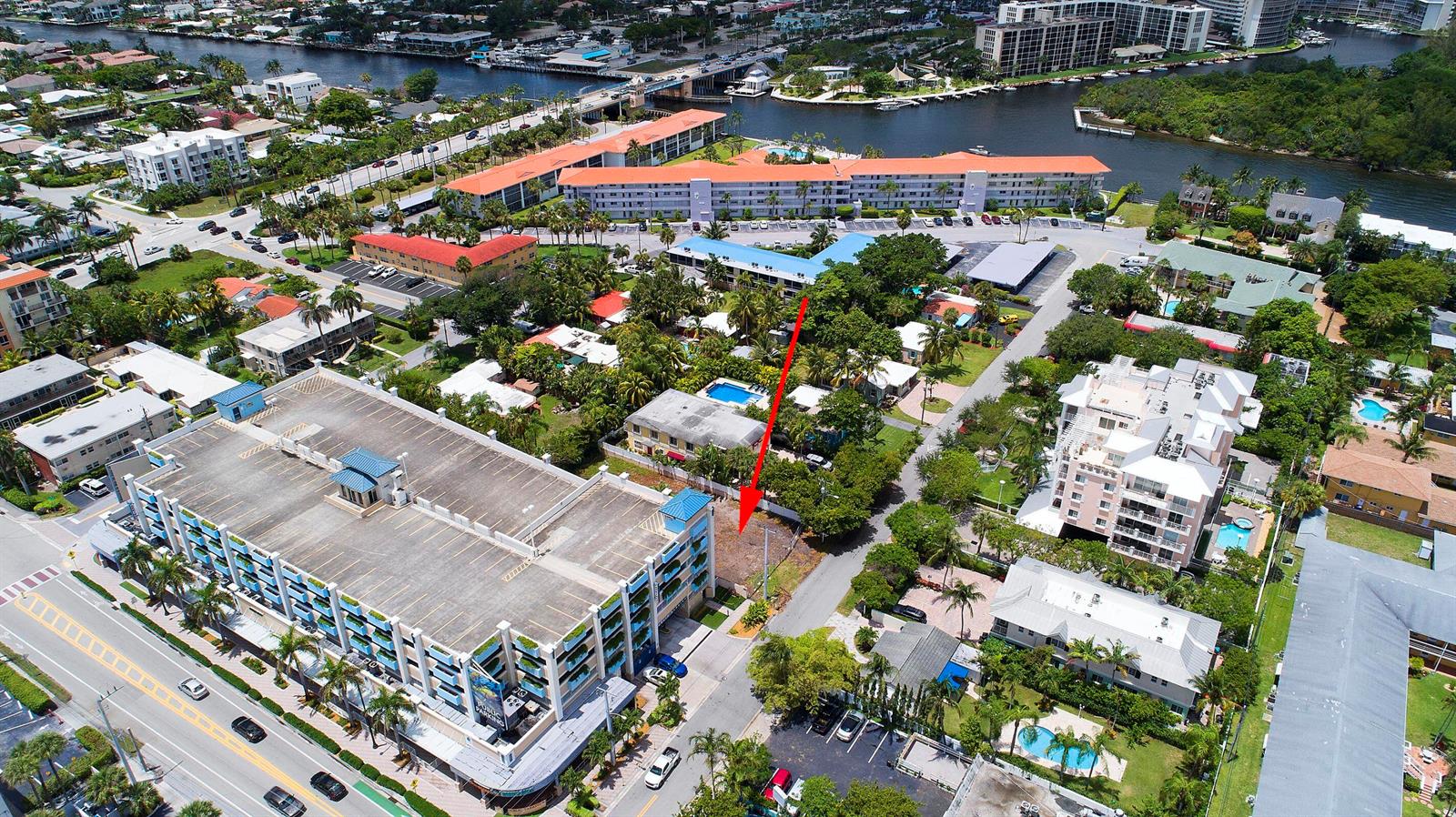 An aerial view shows a vacant lot situated between a parking garage and residential buildings — 1956 NE 2nd Street, Deerfield Beach FL 33441, DEERFIELD BEACH, FL