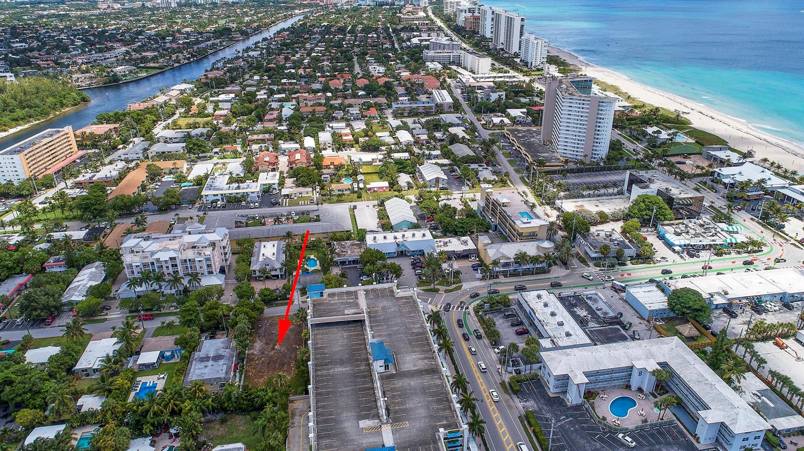 An aerial view shows a vacant rectangular lot marked by a red arrow near buildings — 1956 NE 2nd Street, Deerfield Beach FL 33441, DEERFIELD BEACH, FL