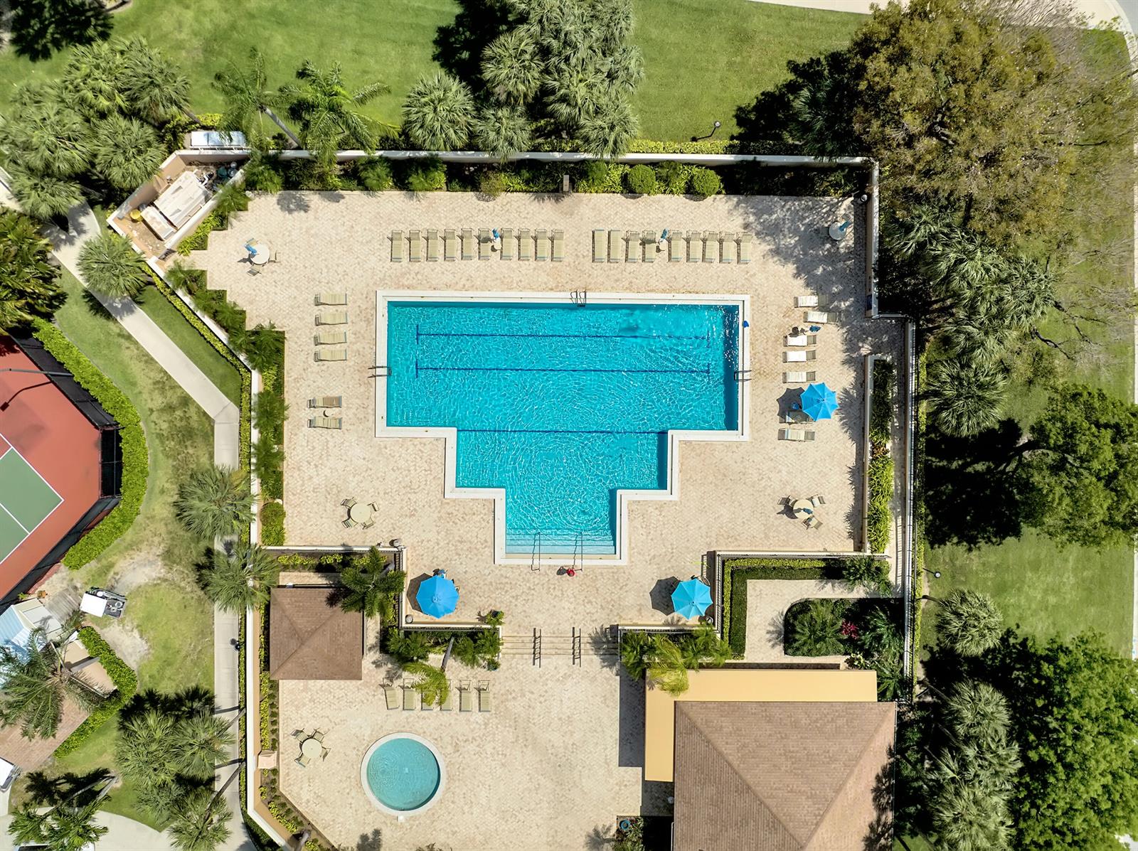An aerial view shows a swimming pool with a spa, lounge chairs, and umbrellas — 118 Ridge Road, Jupiter FL 33477, JUPITER, FL