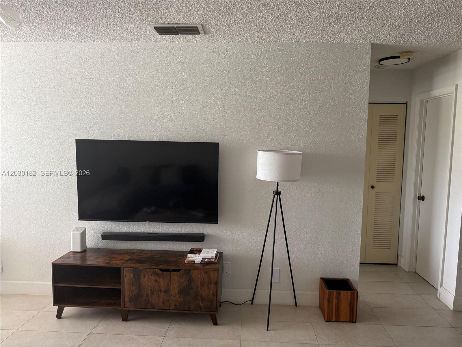 A bathroom features a white vanity with a vessel sink, wall shelves, and a mirror — 3330 N Pinewalk Dr N # 1623, Margate FL 33063, MARGATE, FL