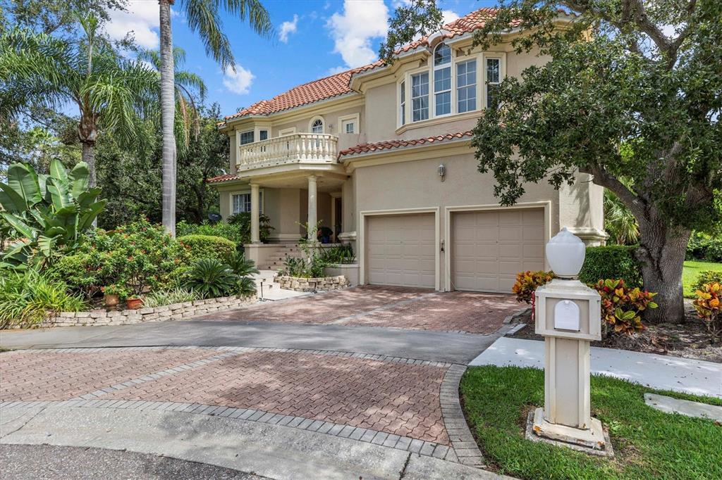 A two-story stucco house with a tile roof, balcony, and two-car garage — 5914 LA ROSA LANE, APOLLO BEACH, FL