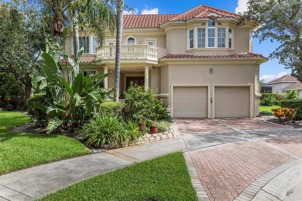 A two-story house with a red tile roof, balcony, and a two-car garage — 5914 LA ROSA LANE, APOLLO BEACH, FL