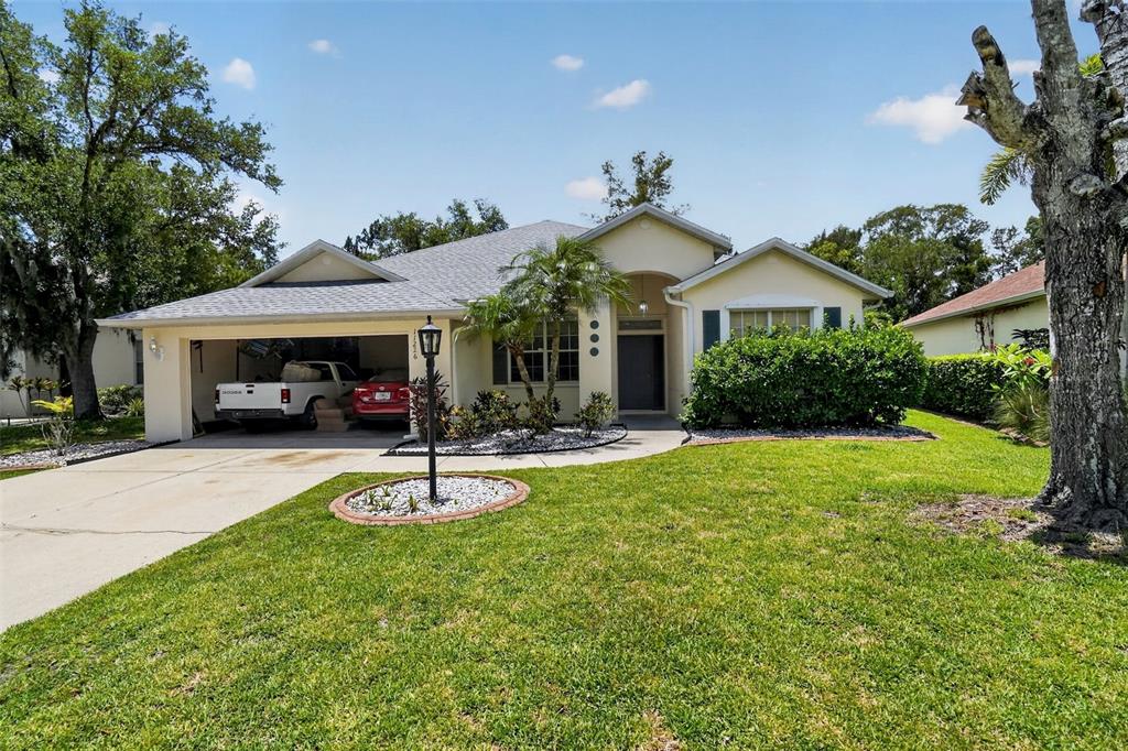 A single-story house with a two-car garage, a front lawn, and a paved driveway — 11226 PRIMROSE CIRCLE, BRADENTON, FL